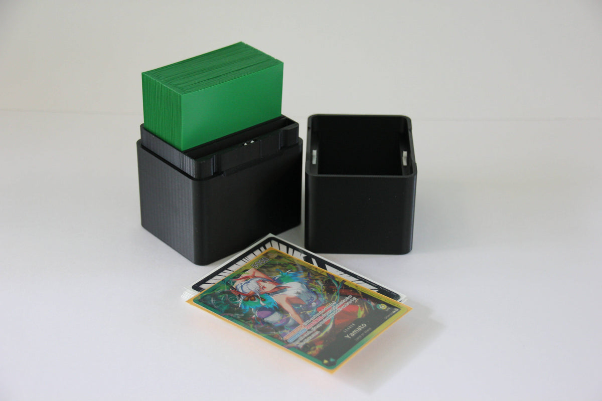 standard_one_piece|One Piece Standard deck box split into its two compartments with a sleeved deck loaded and a Yamato leader card in front