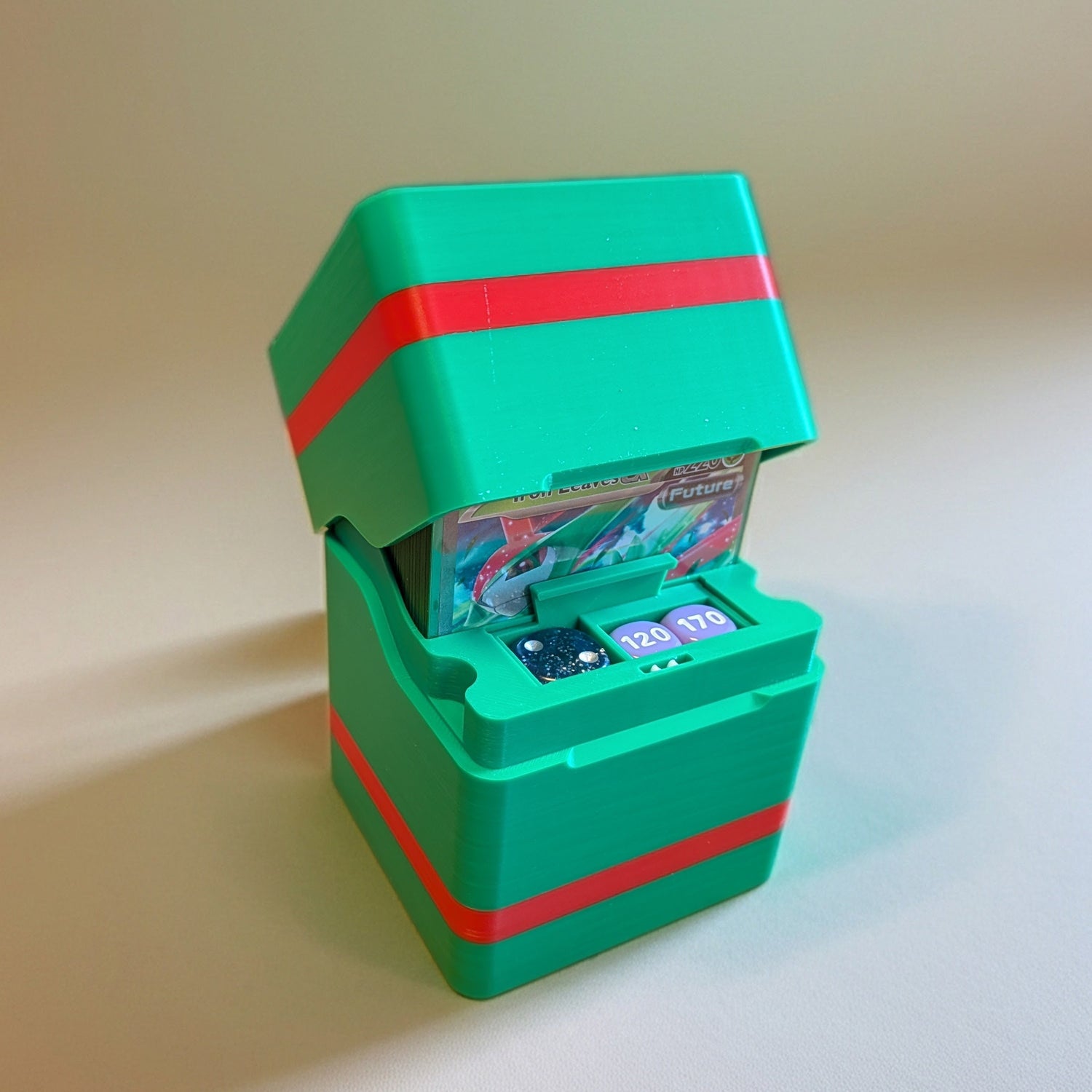 standard_pokemon|Green and red Pokémon Standard deck box with the lid open, showing cards and damage-counter dice