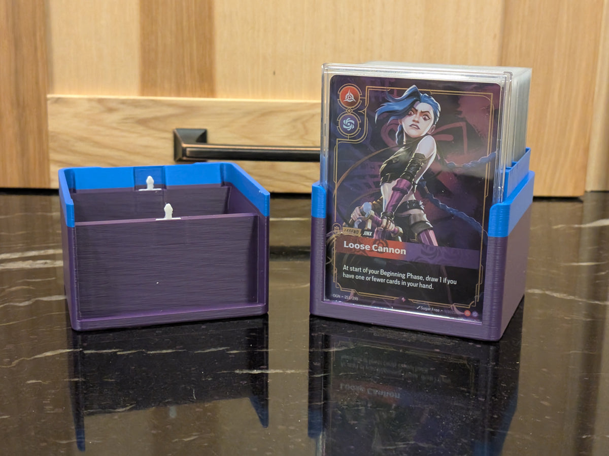standard_riftbound|Riftbound Standard deck box in two halves, one loaded with a sleeved deck and Jinx legend card, the divided empty half beside it