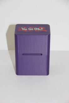 standard_yugioh|Purple Yu-Gi-Oh deck box on its side showing the front card slot