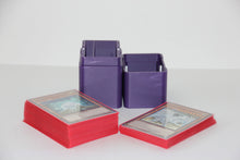 standard_yugioh|Purple Yu-Gi-Oh deck box standing open beside two sleeved deck stacks